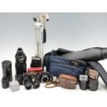A group of cameras, lenses and accessories, including a Chinon CM-3 and CM-4 film camera body, an