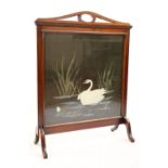 An early 20th Century mahogany fire screen with embroidered insert, 82 cm