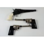 Three vintage toy cap guns including a diecast Remington New Model Army