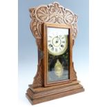 A late 20th Century American shelf clock, having a two-train movement within a foliate oak case with