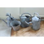 Three vintage galvanized garden watering cans together with a similar bucket, tallest 45.5 cm