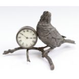 A late 19th Century EPBM novelty combined desk clock and ink well modelled as a bird perched on a
