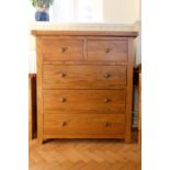 A contemporary blonde oak chest of drawers, 100 cm x 42 cm x 51 cm