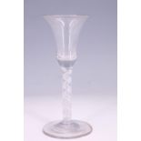 A mid-18th Century helical cable air twist stem wine glass, having a bell-shaped bowl, 15 cm, (