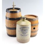 Two 1970s coopered oak barrels by Bass Charrington of Blackpool, together with a stoneware '