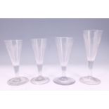 Four Georgian wheel-cut ale glasses, tallest 16 cm