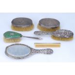 Sundry silver-backed brushes, a comb and a Victorian hand mirror and hair brush pair