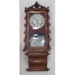 An early 20th Century parquetry inlaid walnut American wallclock, having a later face marked '