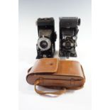 A Kershaw Eight-20 Penguin folding rollfilm camera together with a similar Brownie Six-20