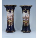 A pair of late 19th / early 20th Century Dresden cobalt blue porcelain vases each of waisted form