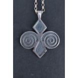 A cased Ola Gorie white metal pendant necklace, of geometric form between adorsed 'C' scrolls,