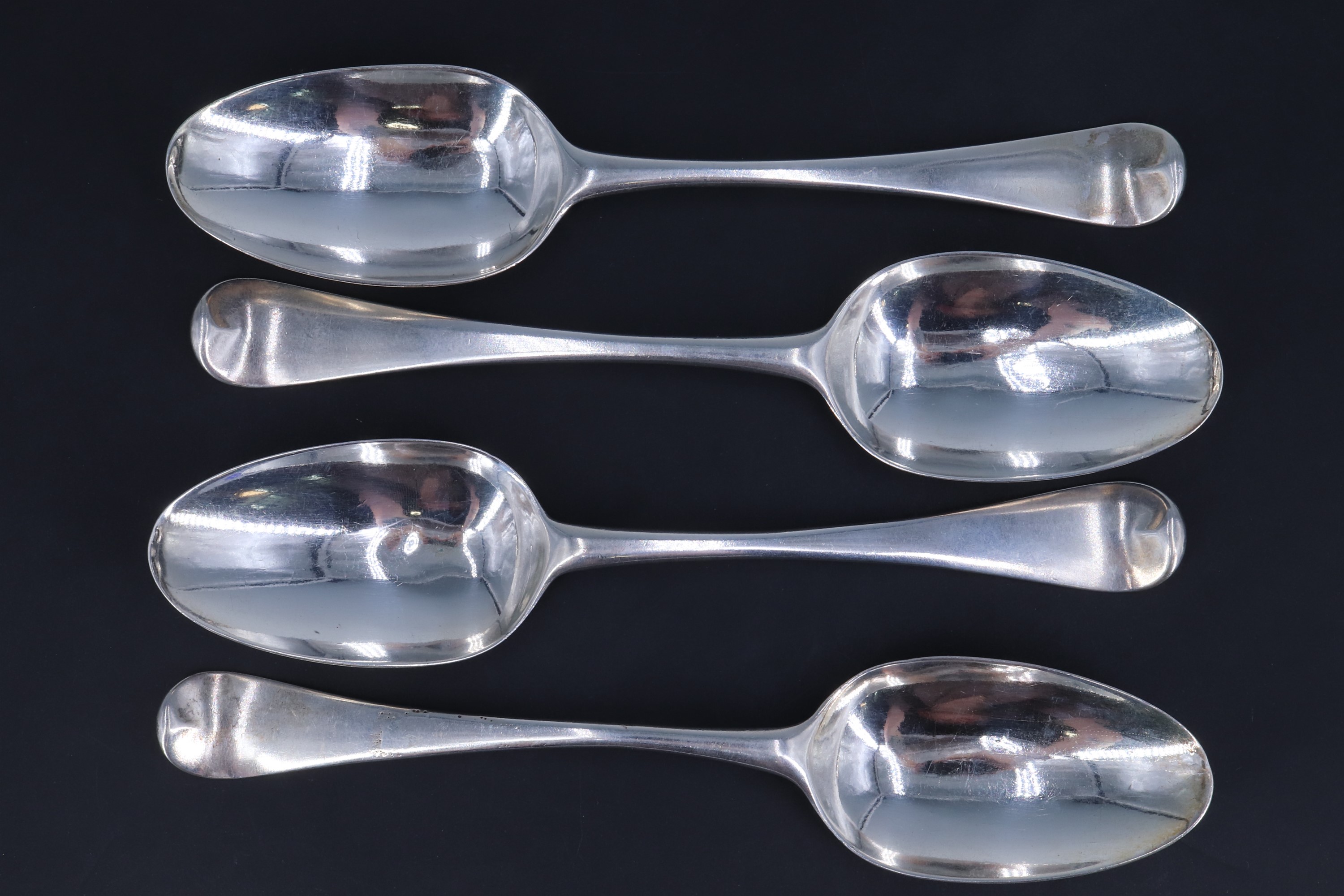 A set of four George IV silver Old English pattern table spoons, bearing engraved crests to the