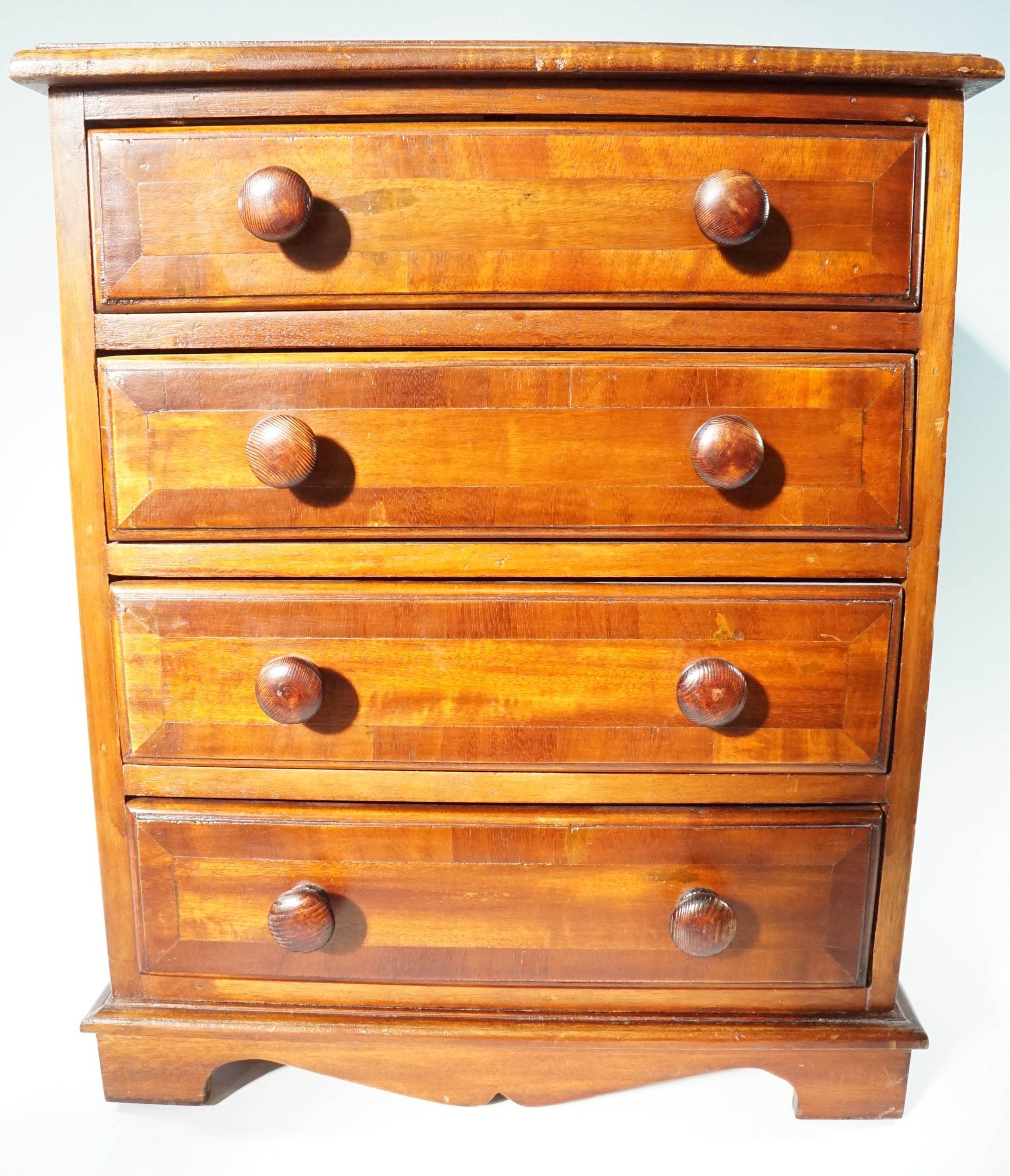 A miniature early 19th Century style mahogany cross-banded chest of drawers, 43 cm x 29 cm x 53 cm