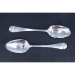 Two George III silver Hanoverian pattern table spoons, one bearing an engraved marriage monogram,