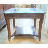 An Empire style mahogany cross-banded and quart-veneered occasional table, having a glass top,