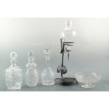 Three late 20th Century cut glass spirit decanters, a cut glass low tazza, and a wine dispenser in a