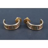 A pair of 1980s three tone 9 ct gold cuff earrings, alternating colours of finely reeded panels