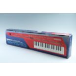 A boxed Yamaha SHS-10 FM digital keyboard