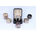 Four 19th Century and later silver napkin rings, including one in presentation case, Birmingham,