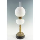 A Victorian / early 20th Century columnar brass and opaque glass oil lamp, having a duplex coronet