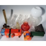 Seven various oil lamp chimneys, including cut glass, amber and frosted, a spirally reeded ruby, and