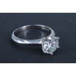 A modern Moissanite solitaire ring, having a two carat brilliant crown set between tapering
