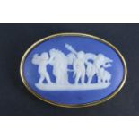 A Wedgwood Jasperware brooch, depicting a classical scene of putti playing musical instruments,