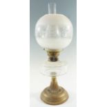 An early 20th Century columnar brass and faceted glass oil lamp, having a duplex coronet burner