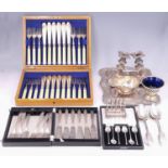 Vintage cases sets of electroplate cutlery, Victorian electroplate candlesticks, a tray, toast