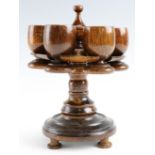 A mid 20th Century turned oak egg-cup stand, 20 cm