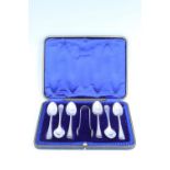 An Edwardian cased set of silver tea spoons with sugar tongs, beaded Hanoverian Pattern, JR,