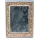 An early 20th Century Arts and Crafts influenced copper framed wall mirror, 29.5 x 23 cm overall