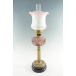 A Victorian columnar brass and amethyst glass oil lamp, having a duplex coronet burner and mildly