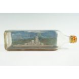 A vintage hand-painted war ship in a glass bottle, circa 1940s, 26 cm