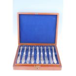 A mahogany cased set of 12 Victorian silver fish knifes, John Gilbert, Birmingham, 1862, weighted (