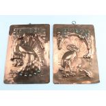 A pair of Arts and Crafts copper wall plaques 'Ye Stork' and 'Ye Peacock', repoussé decorated with