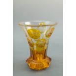 An early 20th Century Bohemian amber flashed glass vase, having an octagonal base rising to a