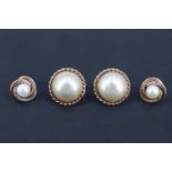 Two pairs of 9 ct gold pearl stud earrings, comprising a pair, each having a 6 mm pearl set within