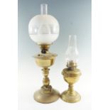 Two early 20th Century brass oil lamps, respectively having single duplex coronet burners, larger