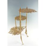 A cast brass three-tiered jardiniere stand, decorated in a butterfly pattern, late 20th Century,