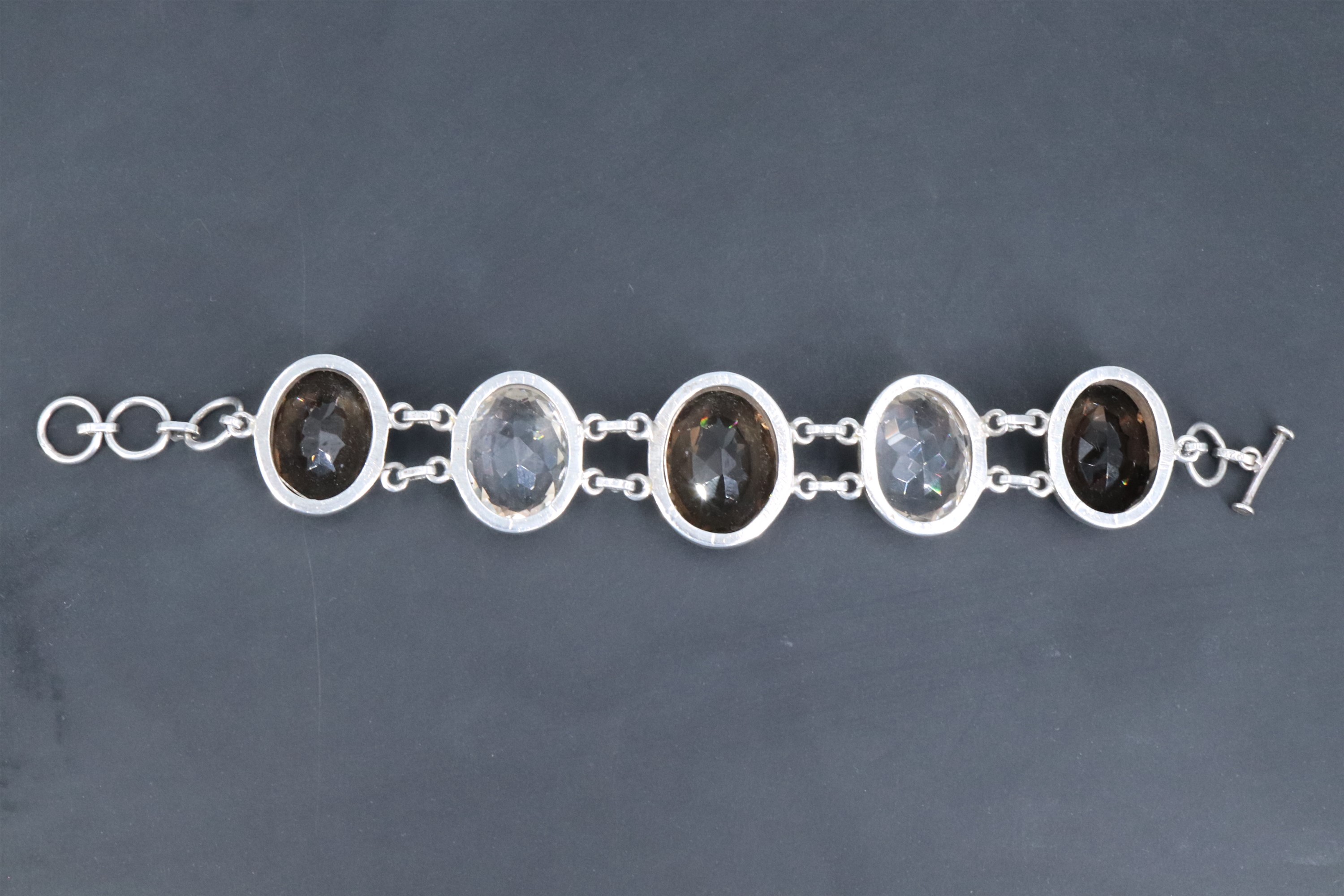 A contemporary white metal bracelet of large facet-cut oval smoky quartz and rock crystal jewels, - Image 3 of 4