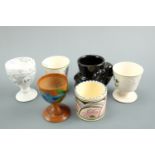 A large quantity of ceramic, electroplate and treen egg cups