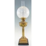 An early 20th Century columnar brass oil lamp, having a stepped square pedestal base with a