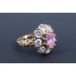 A late 20th Century pink and white beryl daisy-set finger-ring, the central oval 7 x 5 mm