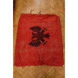 An early-to-mid 20th Century printed cotton single-sided flag of Albania banner, having ribbon ties,