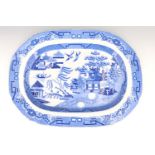 A large blue and white willow pattern ashet, 54 cm x 40 cm