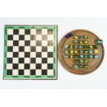 A turned wood solitaire board together with a group of vintage glass marbles and a draughts board,