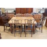 A Victorian mahogany wind out dining table, having heavily reeded legs, two extra leaves and a