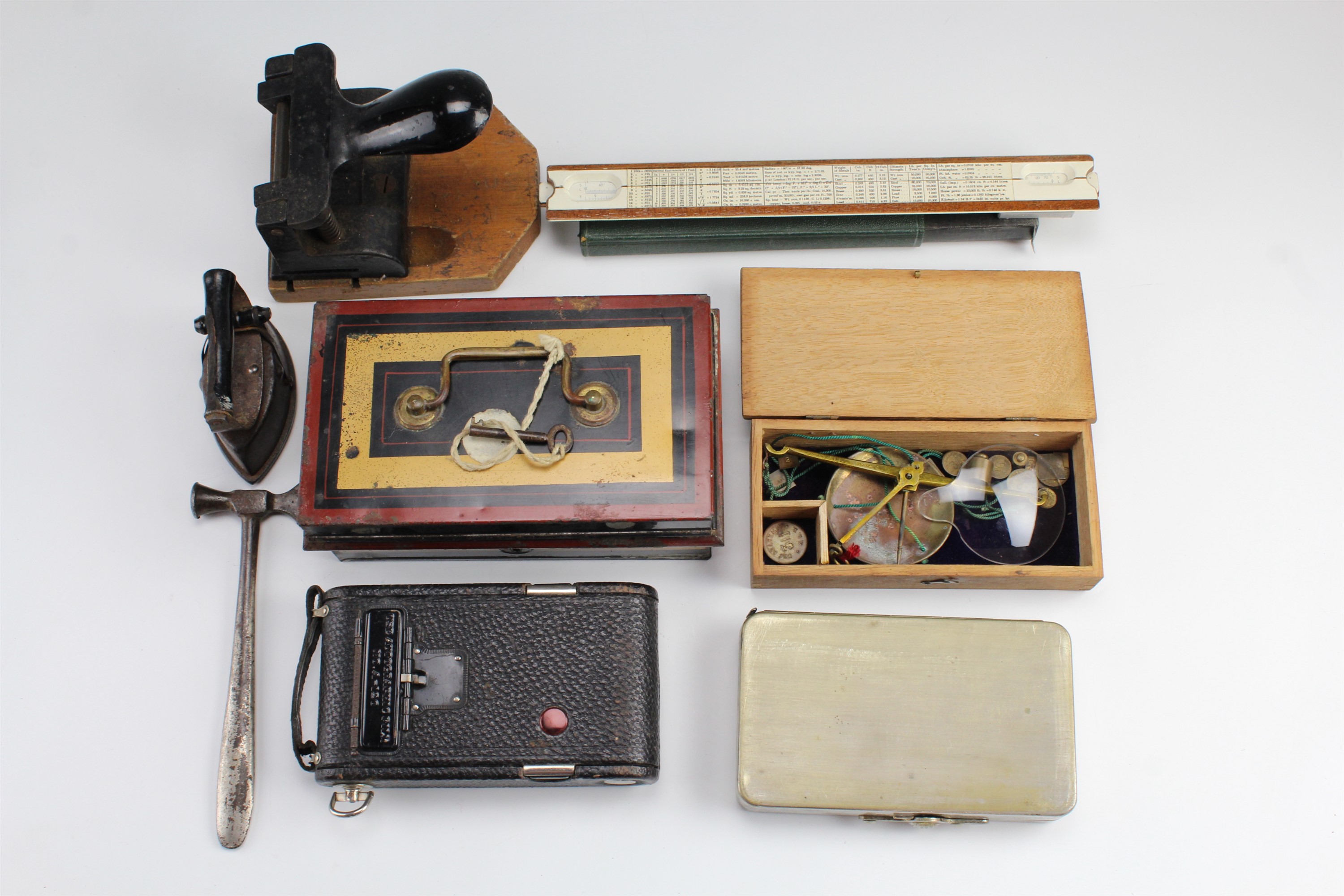A vintage hole punch, petty cash tin, slide rule, bullion scales, Kodak folding camera, etc