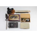 A vintage hole punch, petty cash tin, slide rule, bullion scales, Kodak folding camera, etc